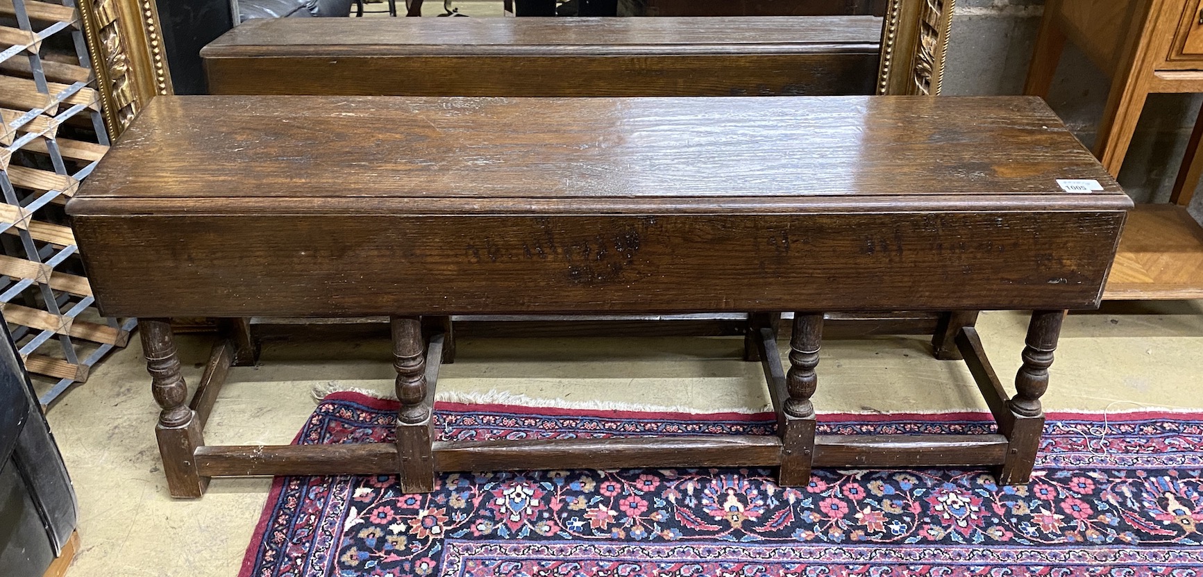 An 18th century style oak drop flap low table, length 130cm, depth 32cm, height 48cm